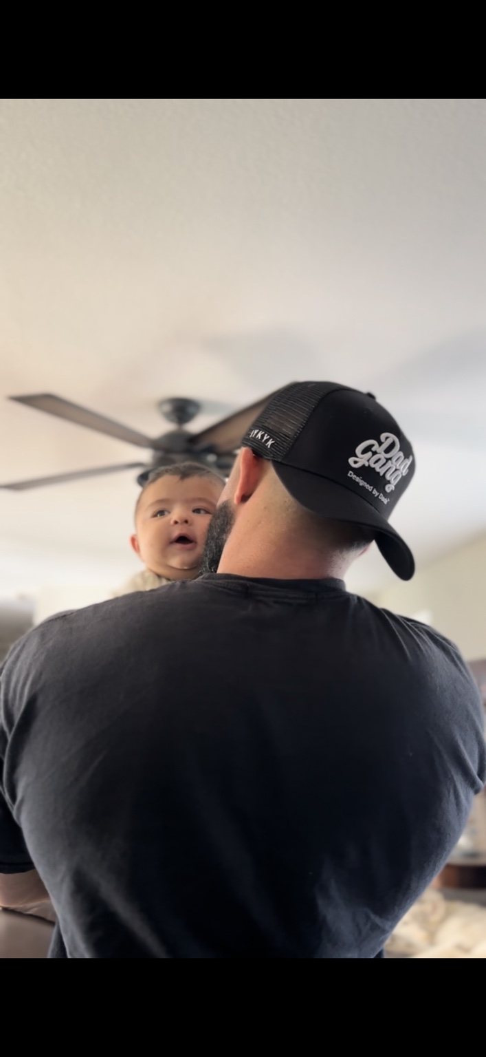 Daniel holding his baby