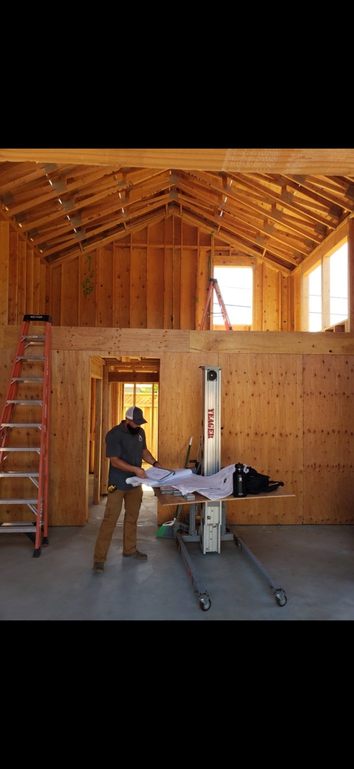 Daniel reviewing construction plans on site